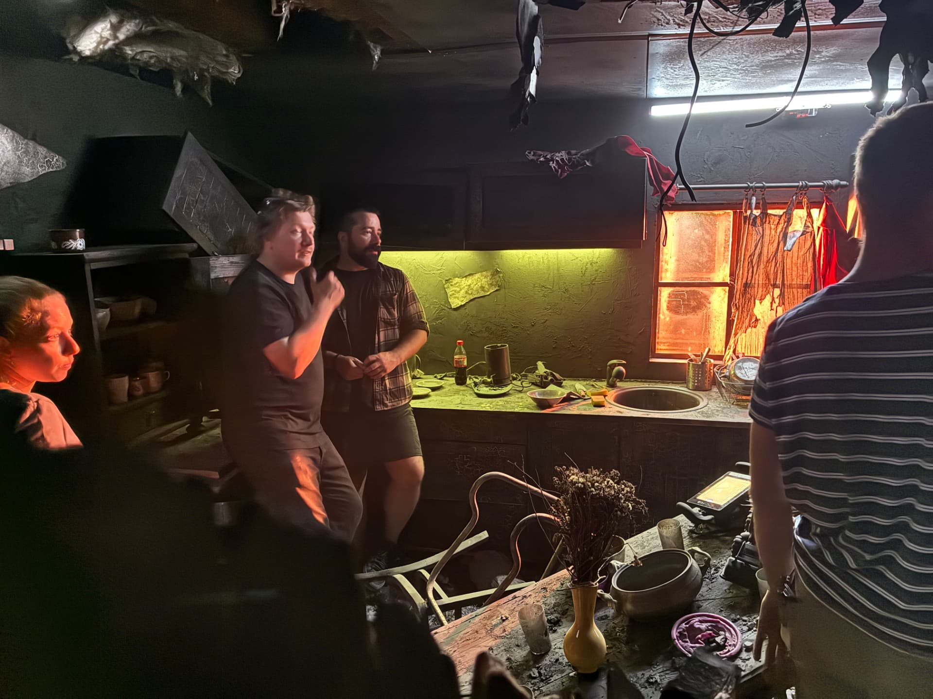 Director briefing the team inside the fire-damaged kitchen set