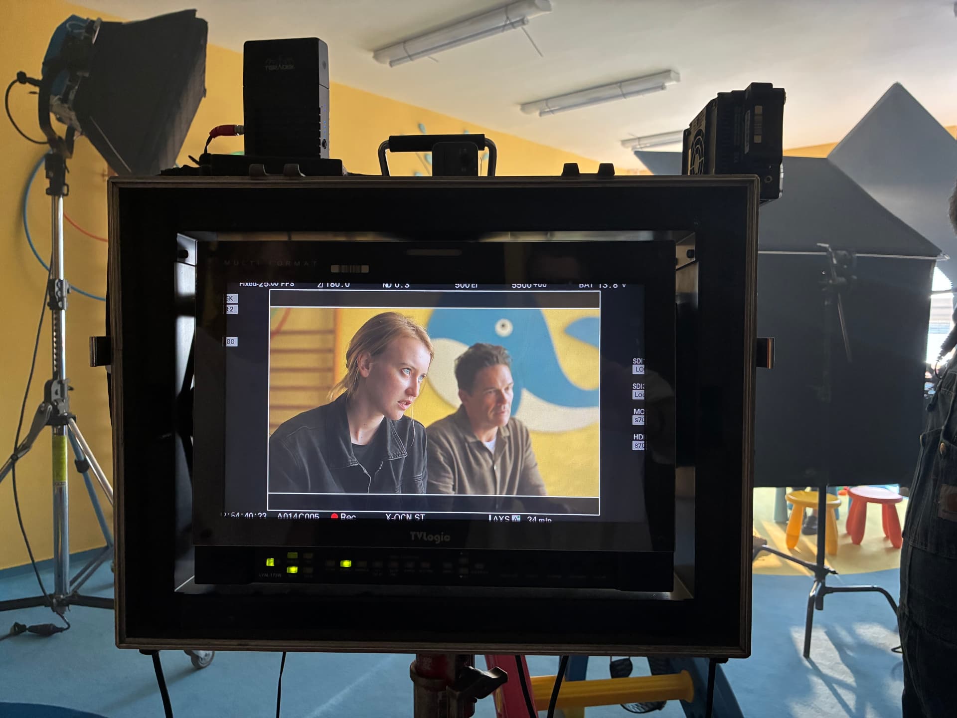 Director's monitor showing two actors mid-scene on the Hear Me set