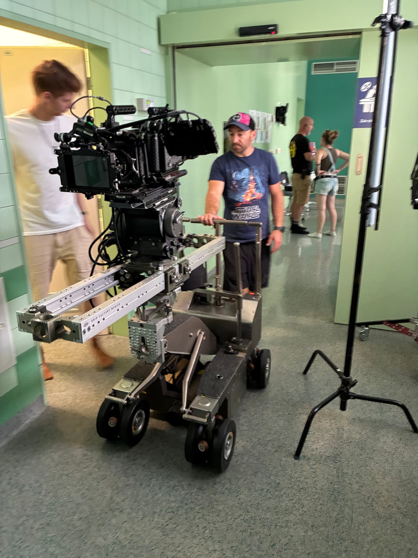 Camera mounted on a dolly in a green hospital hallway
