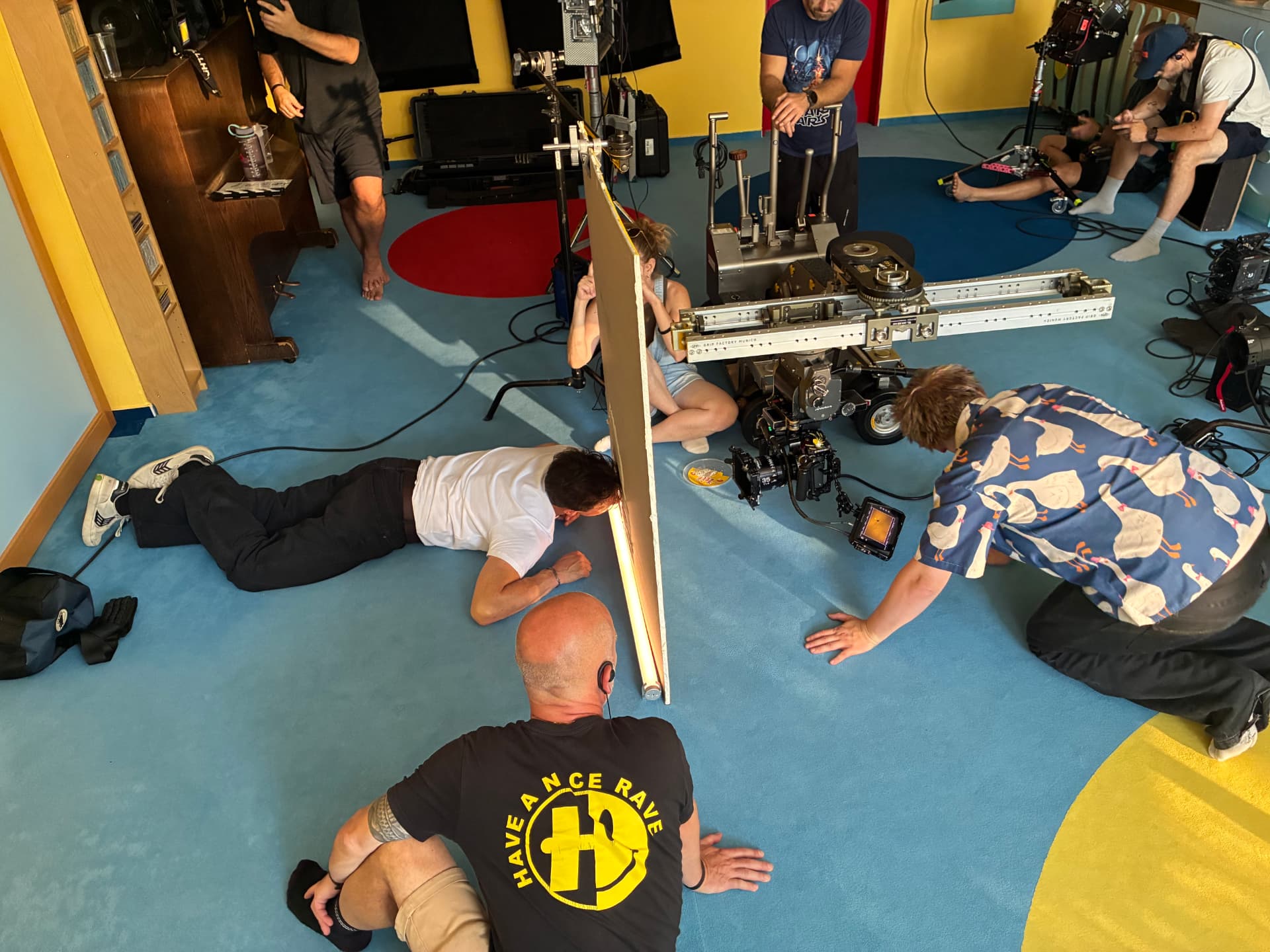 Crew setting up a dolly track and bounce board in the playroom location